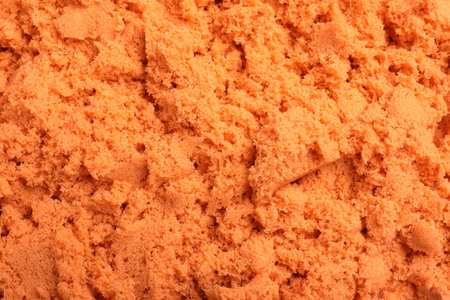 Orange kinetic sand as background, closeup viewの写真素材