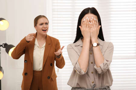 Boss screaming at employee in office. Toxic work environmentの写真素材