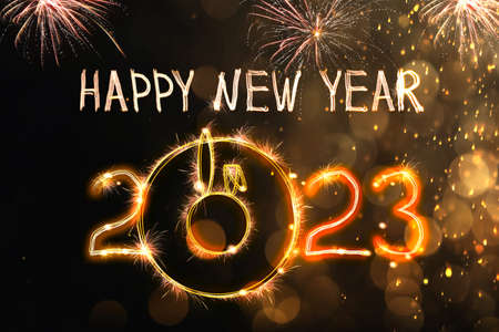 Bright text Happy New 2023 Year made of firework on dark background. Greeting card design