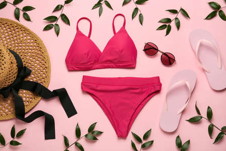 Stylish bikini and beach accessories on pink background, flat layの写真素材