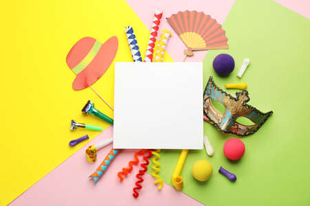 Flat lay composition with carnival items and blank card on color background. Space for textの写真素材