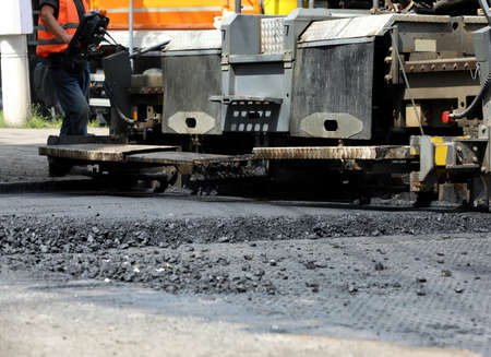 Road repair machinery working on street, closeup view