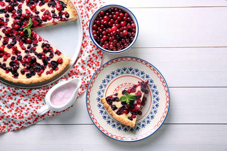 Delicious currant pie and fresh berries on white wooden tableの写真素材