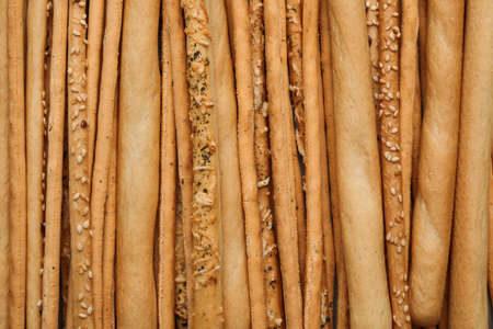 Delicious grissini sticks as background, top viewの写真素材