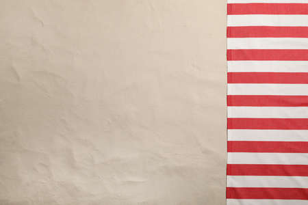 Striped beach towel on sand, top view. Space for textの写真素材