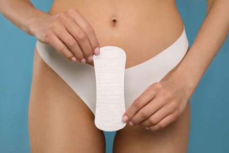 Woman in white panties with menstrual pad on light blue background, closeupの写真素材
