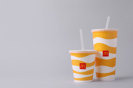MYKOLAIV, UKRAINE - AUGUST 12, 2021: Cold McDonald's drinks on light background. Space for textのeditorial素材