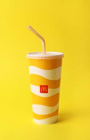 MYKOLAIV, UKRAINE - AUGUST 12, 2021: Cold McDonald's drink on yellow backgroundのeditorial素材