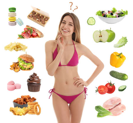 Young slim woman choosing between healthy and unhealthy food on white backgroundの写真素材