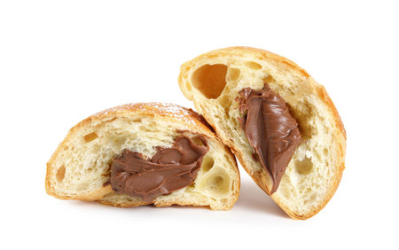 Halves of tasty croissant with chocolate and sugar powder on white backgroundの写真素材