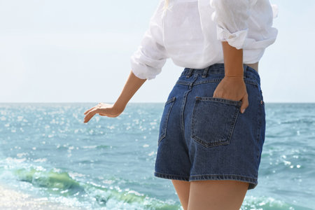 Young woman near sea on summer day, closeup. Space for textの写真素材