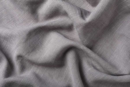 Gray hemp cloth as background, top view. Natural fabric