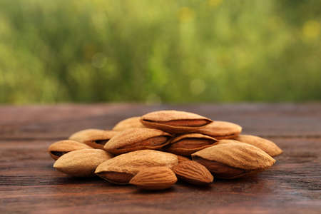 Almonds on wooden table outdoors, closeup viewの写真素材