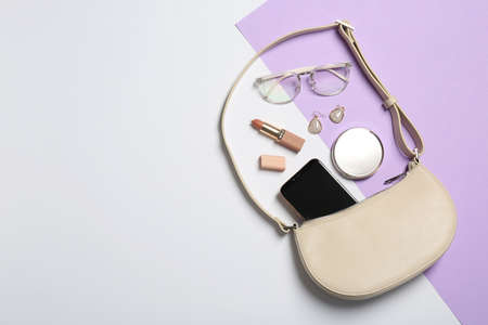 Stylish women's bag and different stuff on color background, flat lay. Space for textの写真素材