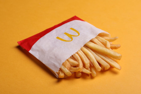MYKOLAIV, UKRAINE - AUGUST 12, 2021: Small portion of McDonald's French fries on orange backgroundのeditorial素材