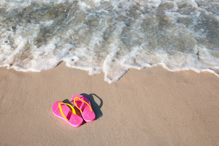 Stylish flip flops on beach. Space for textの写真素材
