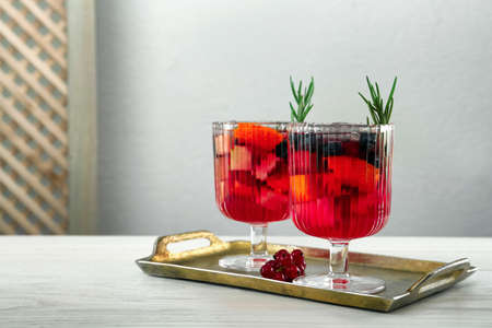 Glasses of Red Sangria on white wooden tableの写真素材