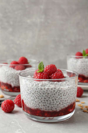 Delicious chia pudding with raspberries and mint on light marble table, space for textの写真素材