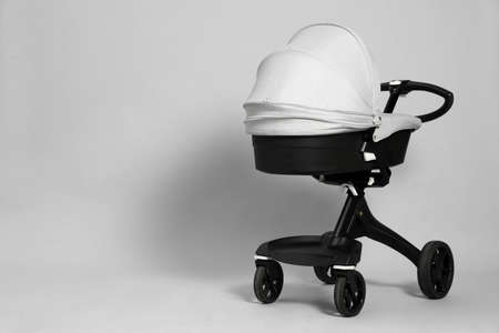 Baby carriage. Modern pram on gray background, space for textの写真素材