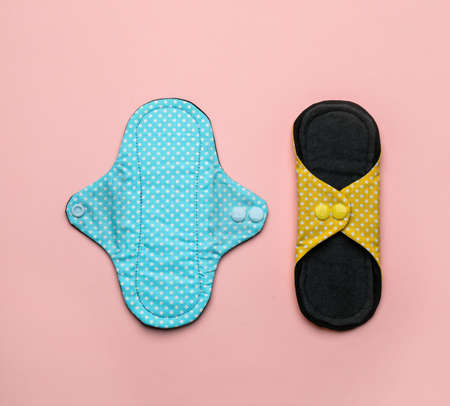 Reusable cloth menstrual pads on pink background, flat layの写真素材