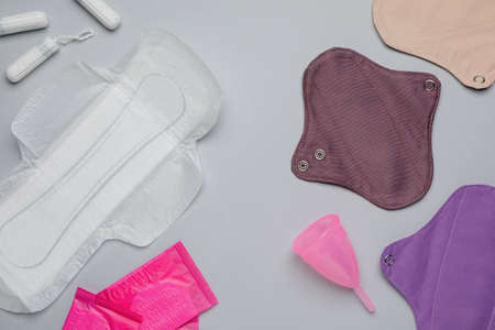 Different menstrual hygiene products on gray background, flat layの写真素材