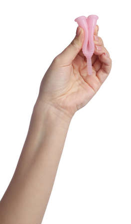 Woman folding pink menstrual cup on white background, closeupの写真素材
