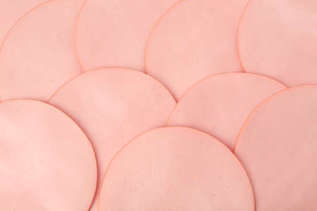 Slices of delicious boiled sausage as background, top view