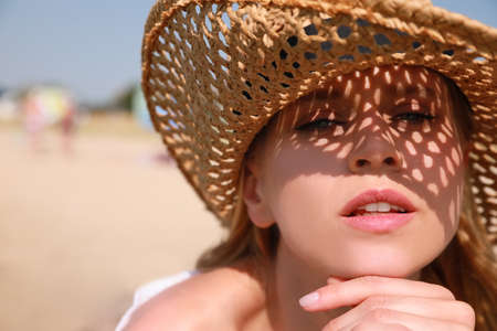 Beautiful woman with straw hat outdoors on sunny day, space for textの写真素材