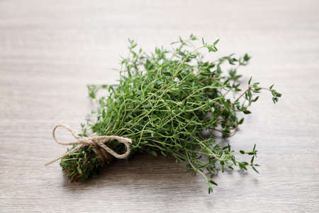 Bunch of aromatic thyme on wooden tableの写真素材