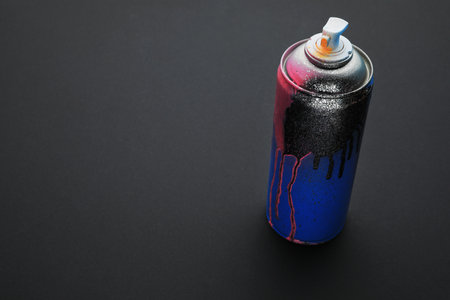 Used can of spray paint on black background, space for text. Graffiti supplyの写真素材