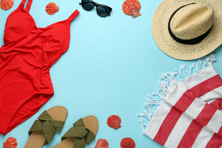 Frame made with different beach objects on light blue background, flat lay. Space for textの写真素材
