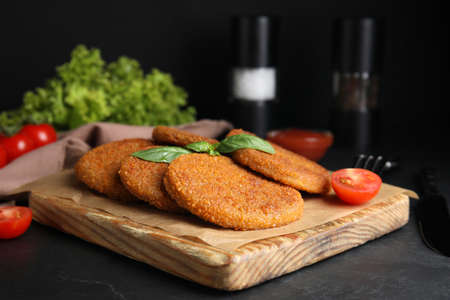 Delicious fried breaded cutlets served on black tableの写真素材