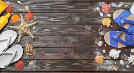 Stylish flip flops and beach objects on wooden background, flat lay. Space for text