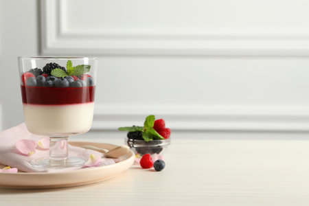 Delicious panna cotta with berries on white wooden table. Space for textの写真素材