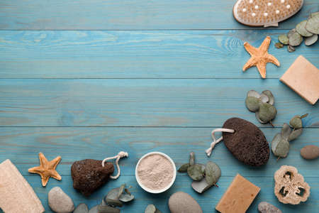 Flat lay composition with pumice stones on turquoise wooden background. Space for text