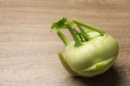 Whole ripe kohlrabi plant on wooden table. Space for textの写真素材