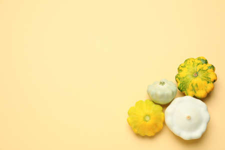 Fresh ripe pattypan squashes on beige background, flat lay. Space for text