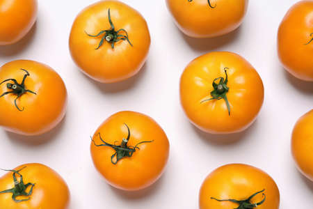 Fresh ripe yellow tomatoes on white background, top view