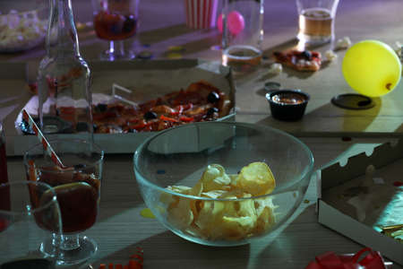 View of messy table with drinks and leftovers after partyの写真素材