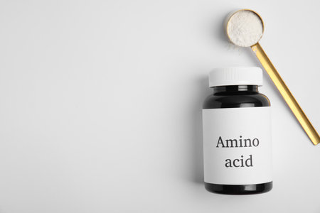 Amino acid powder and jar on white background, top viewの写真素材
