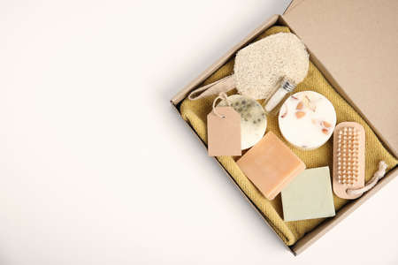 Cardboard box with eco friendly personal care products on white background, top view. Space for textの写真素材