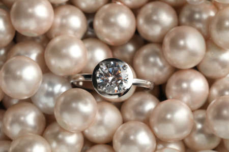 Beautiful decor pearls and engagement ring, top viewの写真素材