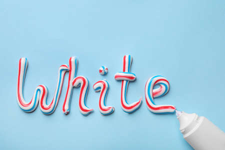 Tube and word White made of toothpaste on light blue background, flat layの写真素材