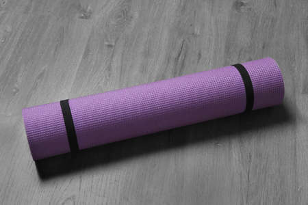 Bright rolled camping mat on gray wooden backgroundの写真素材