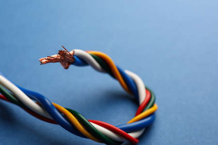Many twisted electrical wires on blue background, closeupの写真素材