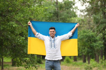 Man in vyshyvanka with flag of Ukraine outdoorsの写真素材