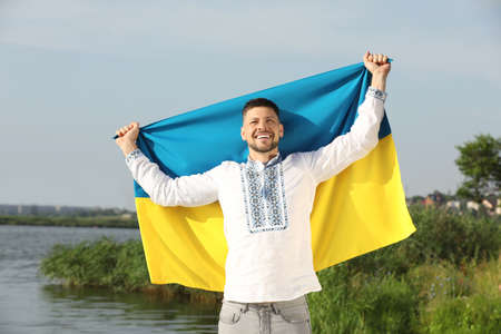 Man in vyshyvanka with flag of Ukraine outdoorsの写真素材