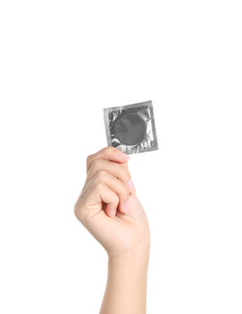 Woman holding condom on white background, closeupの写真素材