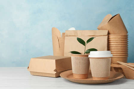 Disposable eco friendly products on white wooden table