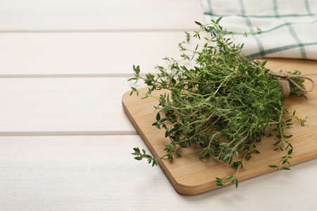 Bunch of aromatic thyme on white wooden table, closeup. Space for textの写真素材